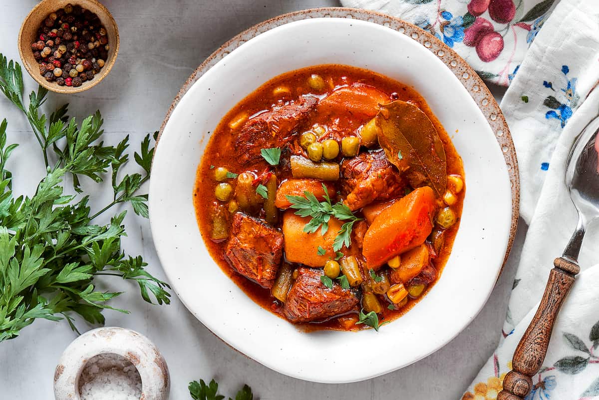 An overhead shot of a bowl of Mulligan stew on a table.