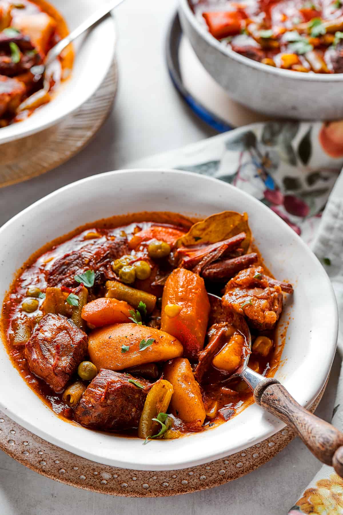 Bowls of Mulligan stew are shown on a flowered tablecloth.