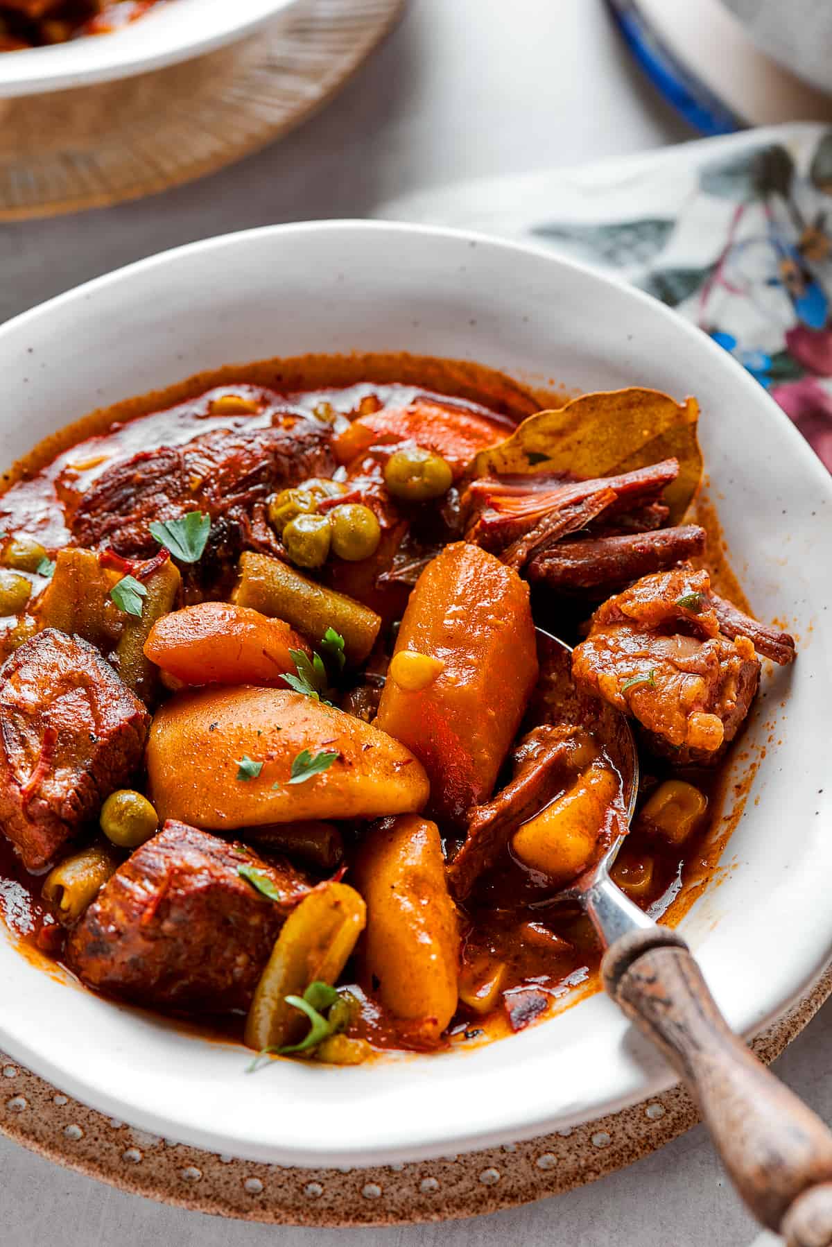 A close up shot of a bowl of Muliigan stew with a spoon.