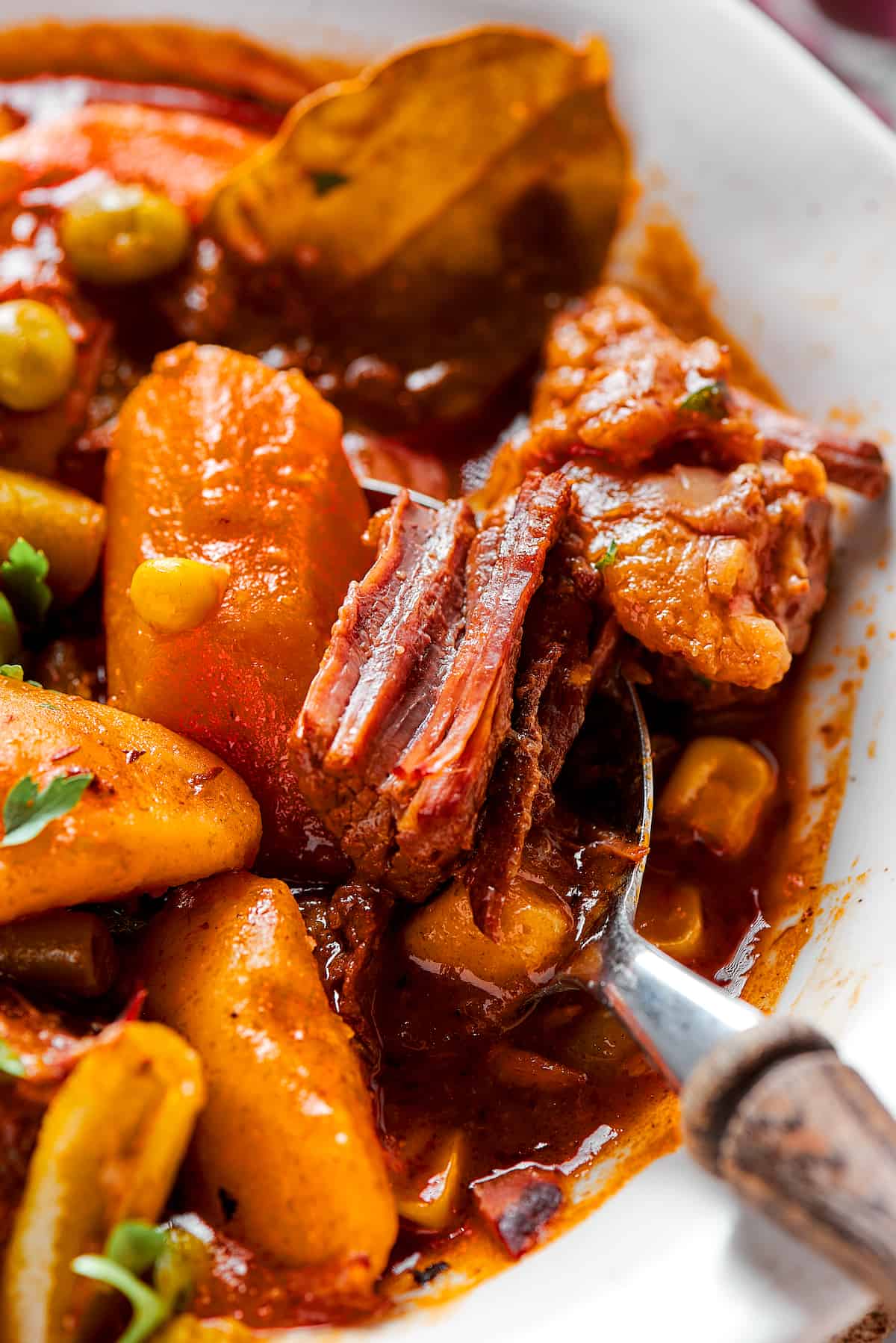 A close up shot of a bowl of Muliigan stew with a spoon.