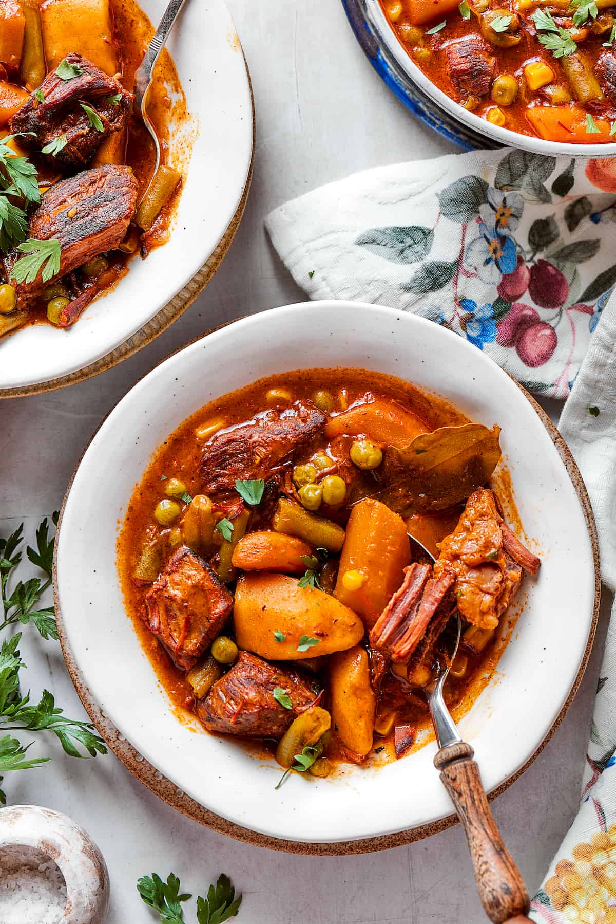 Bowls of Mulligan stew are shown on a flowered tablecloth.