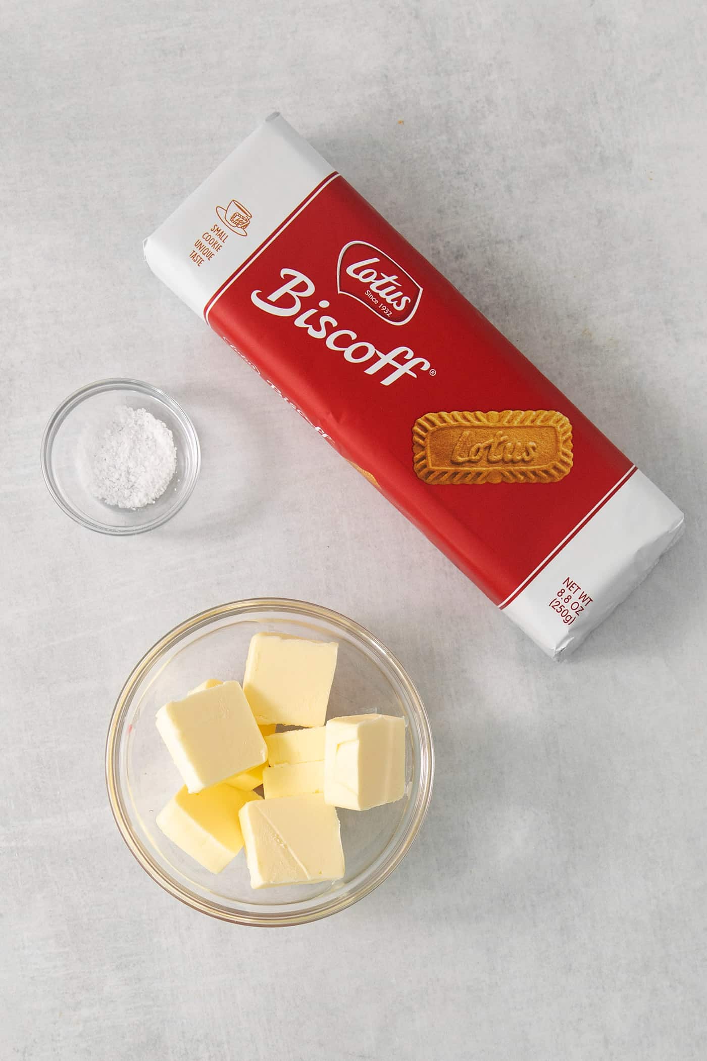 The ingredients needed to make biscoff cookie crust are shown: biscoff cookies, butter, and salt.