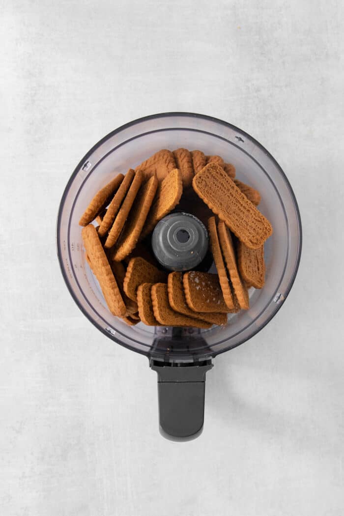 A top down shot of biscoff cookies in a food processor.