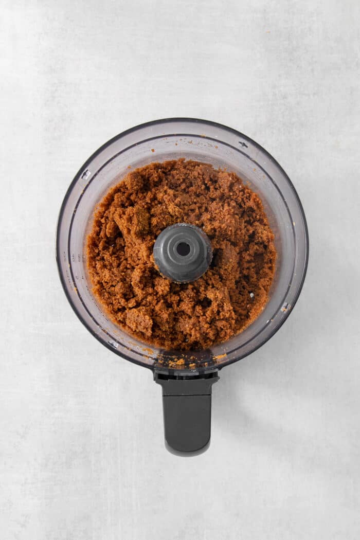 A food processor processes cookies for a crust.