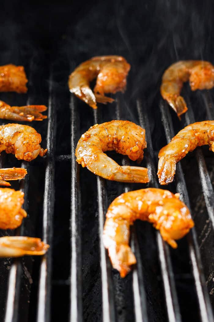 Shrimp is shown cooking on the grill.