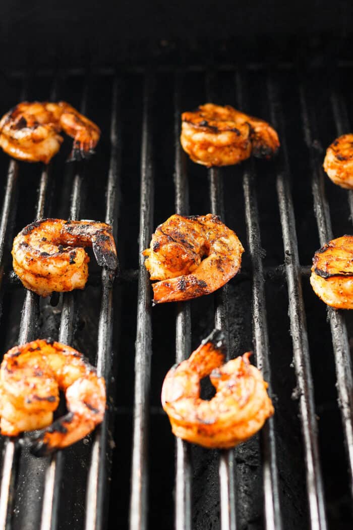 Shrimp is shown cooking on the grill.