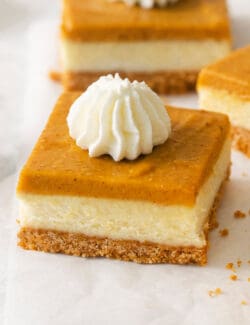 A close up of a square of pumpkin cheesecake bars.