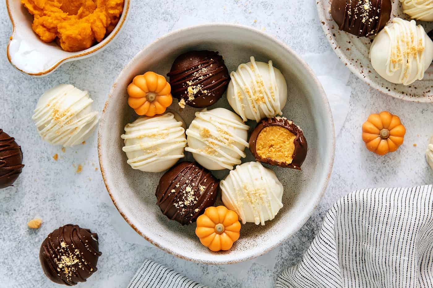 A top down shot of a white bowl of pumpkin pie truffles.