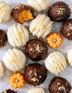 Pumpkin pie truffles and mini pumpkins are shown on a white background.