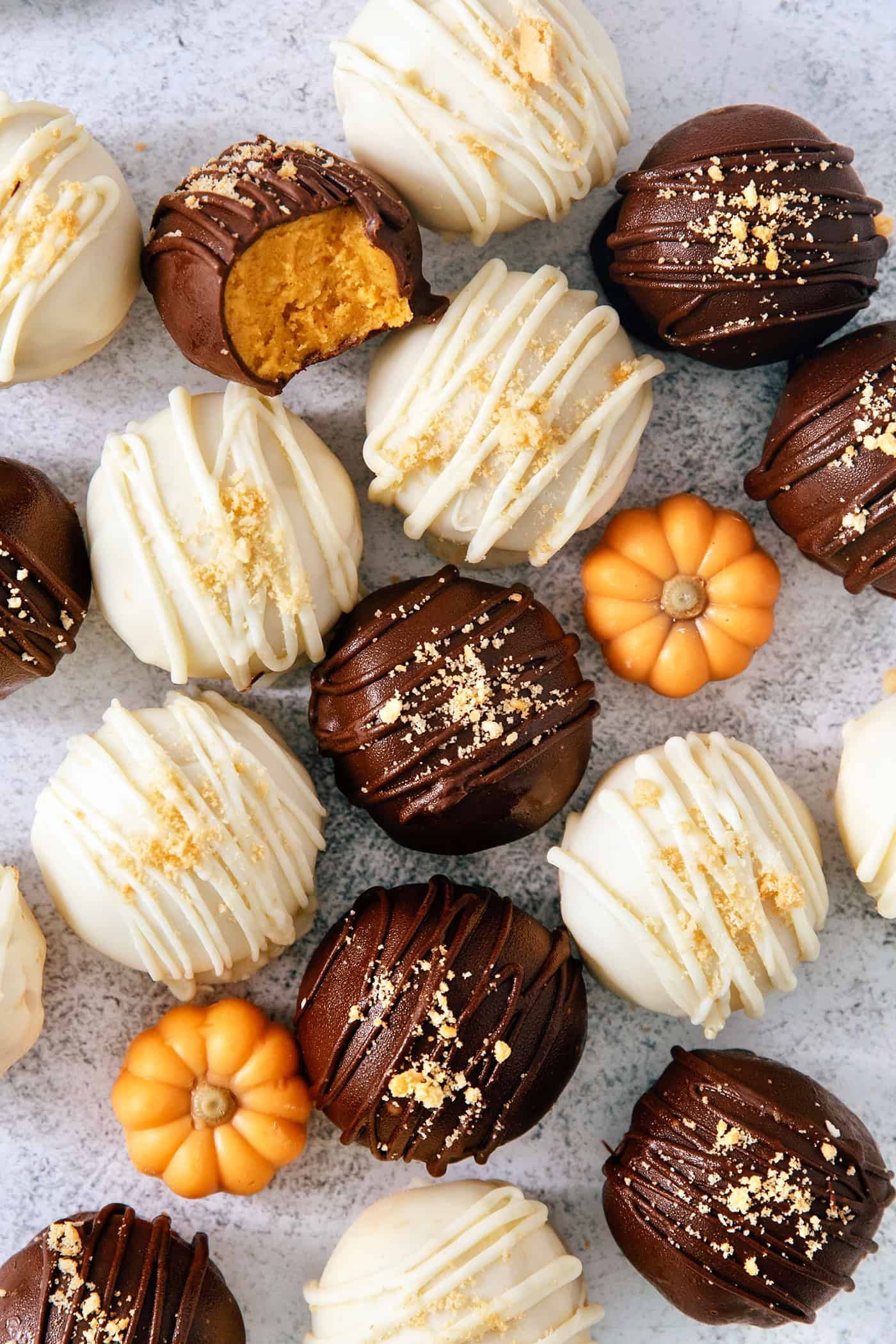 Pumpkin pie truffles and mini pumpkins are shown on a white background.