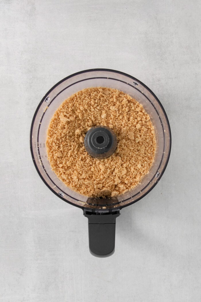 A food processor processes cookies into curmbs.