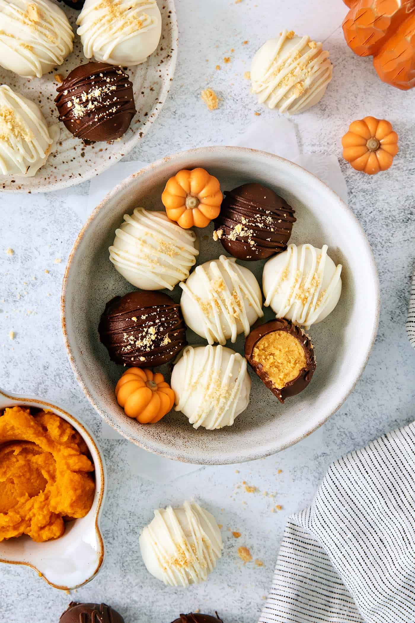 A top down shot of a white bowl of pumpkin pie truffles.