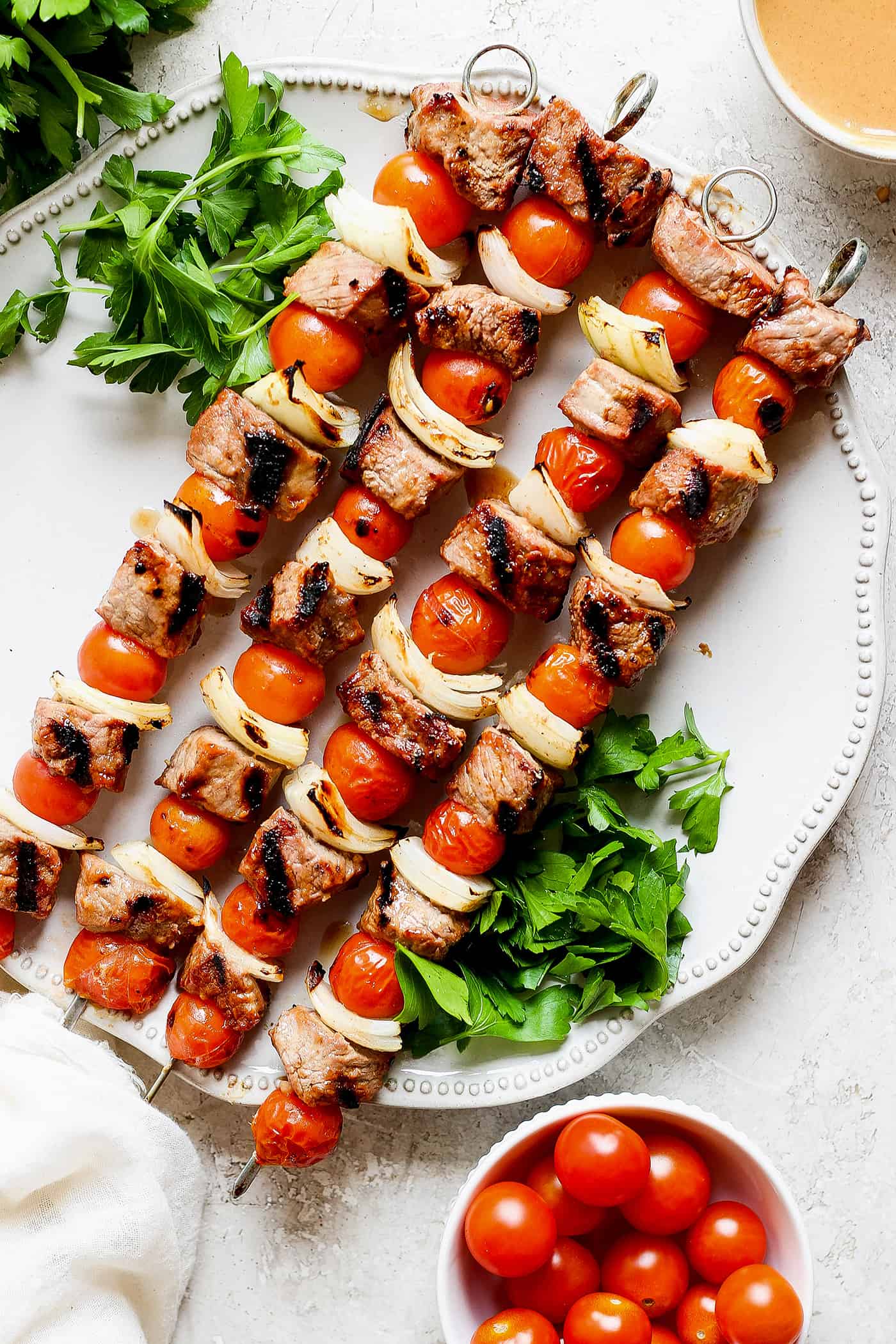 Honey mustard beef kabobs are shown together on a white plate.