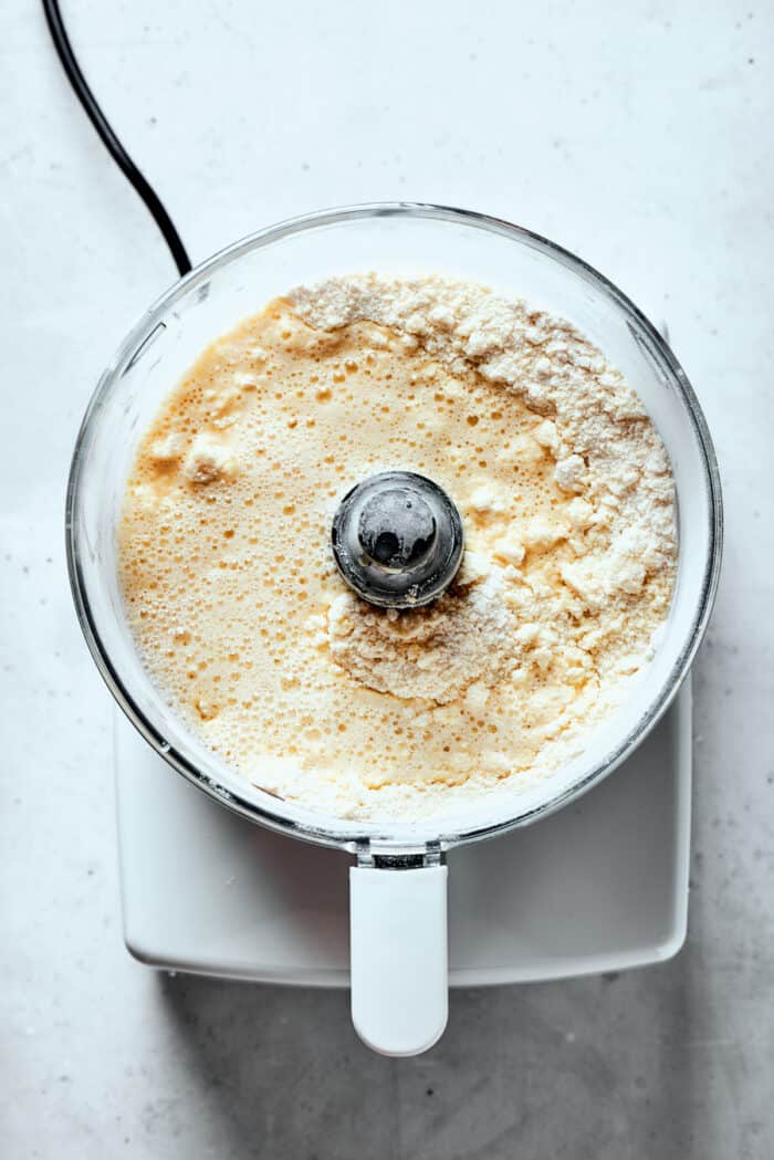 Ingredients for pastry dough are shown in a food processor.