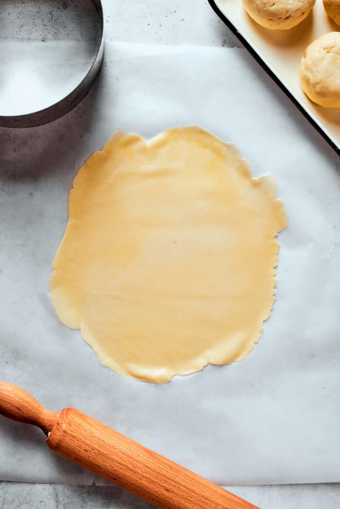 A thin sheet of pastry dough on a white background.
