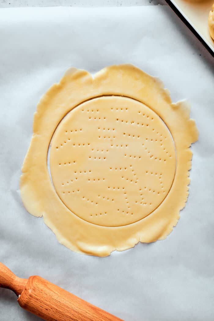 A piece of pastry dough with a circle indentation.