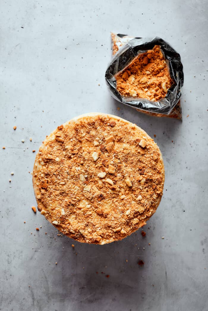 A top down view of a Napoleon cake with a bowl of crushed pastry crumbs next to it.