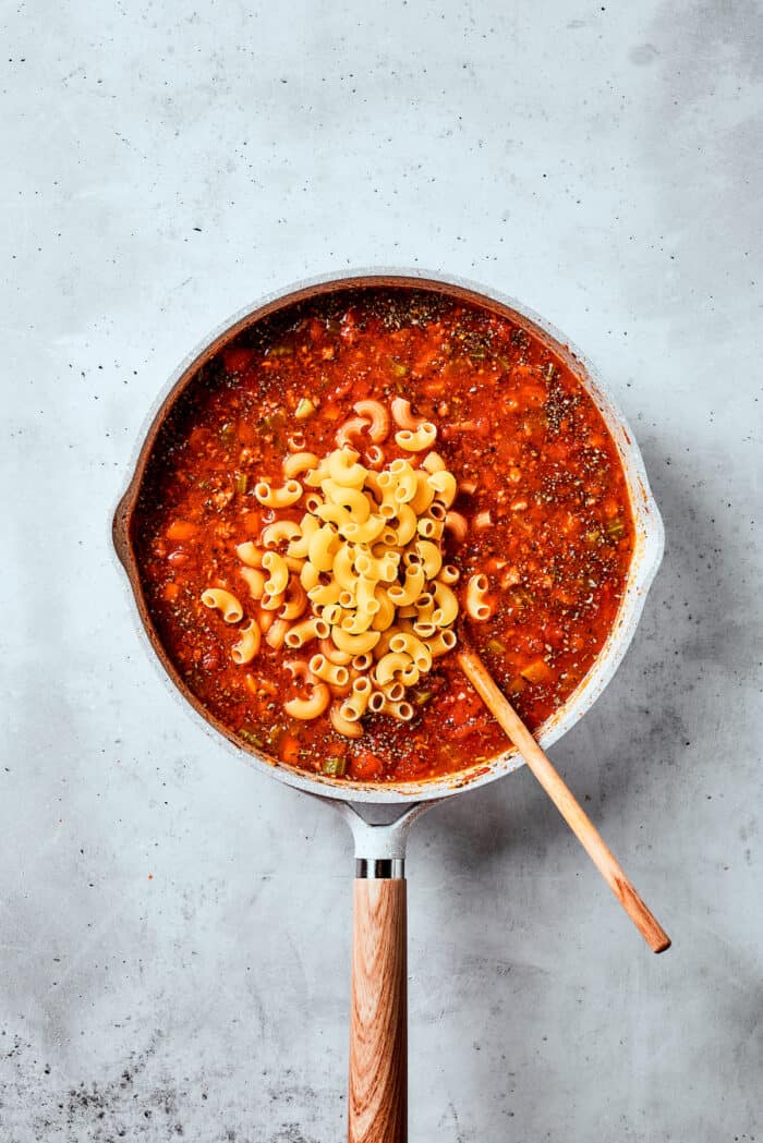 Pasta is shown on top of a pot of pasta fazool.