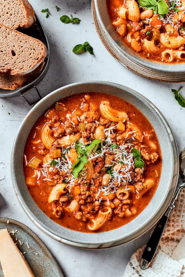 A top down shot of bowls of pasta fazool on a table.