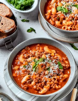 A top down shot of bowls of pasta fazool on a table.