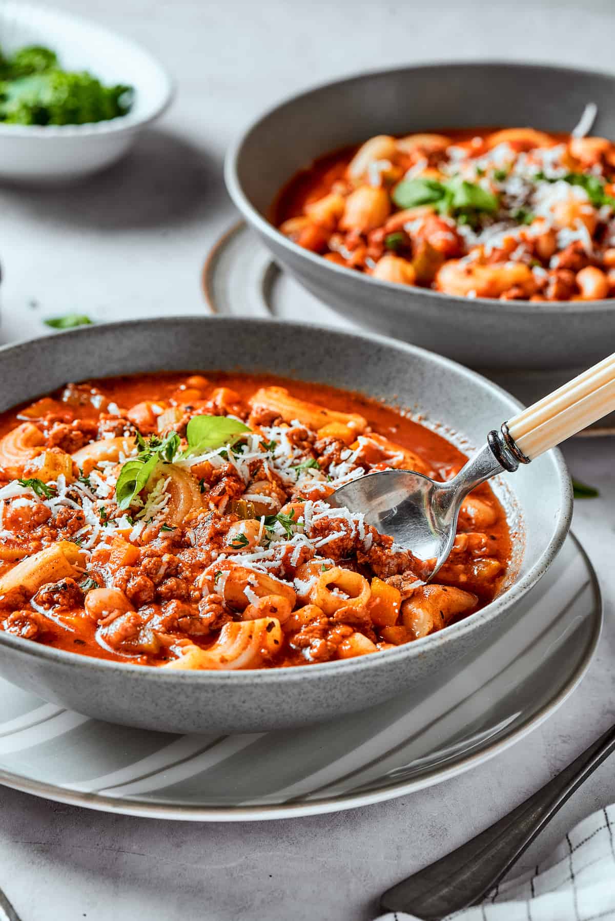 Bowls of pasta fazool on a table.