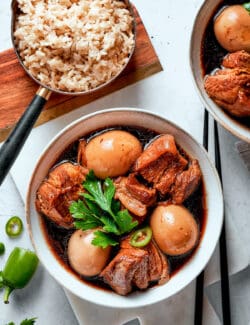 A top down shot of Thit Kho with brown rice.