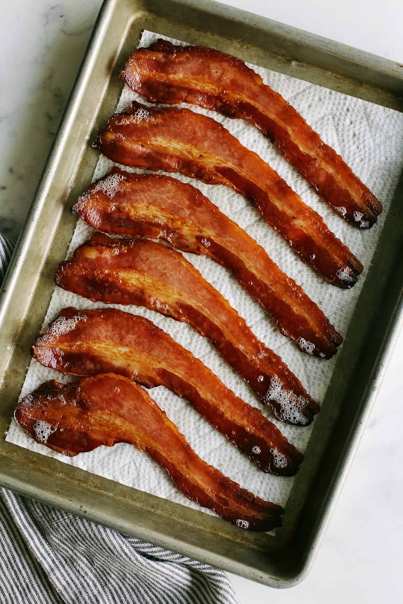a sheet pan with cooked bacon