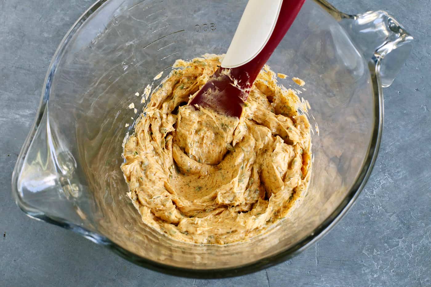 mixing cowboy butter in a clear bowl