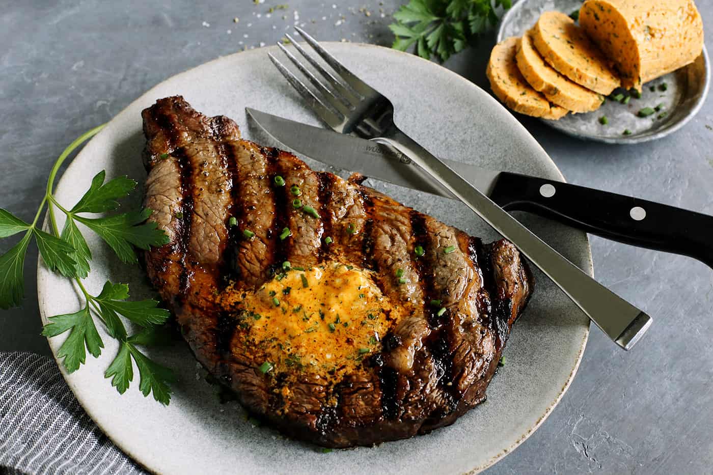 cowboy butter melting over a grilled steak