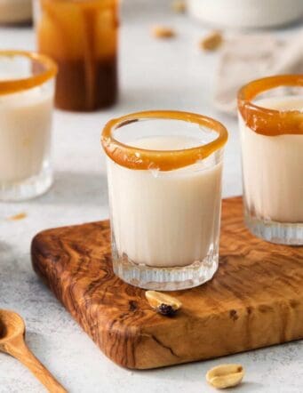 Salted nut roll shot drinks are shown on a cutting board.
