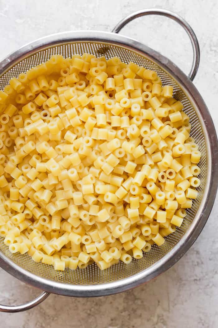 Ditalini pasta is shown in a colander/