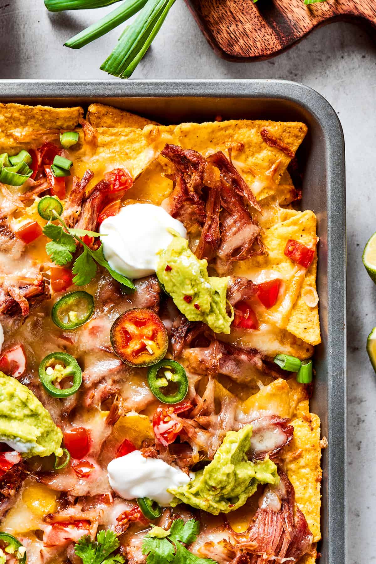 a pan of baked pulled pork nachos