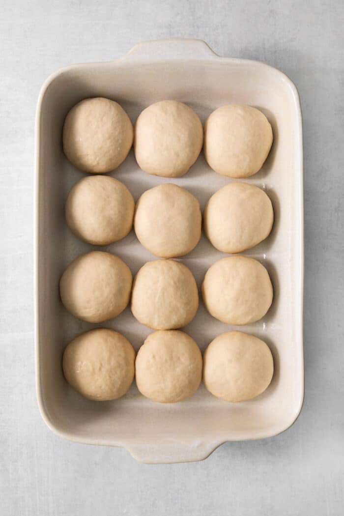 Rolls of dough are shown in a pan to make rhodes rolls.