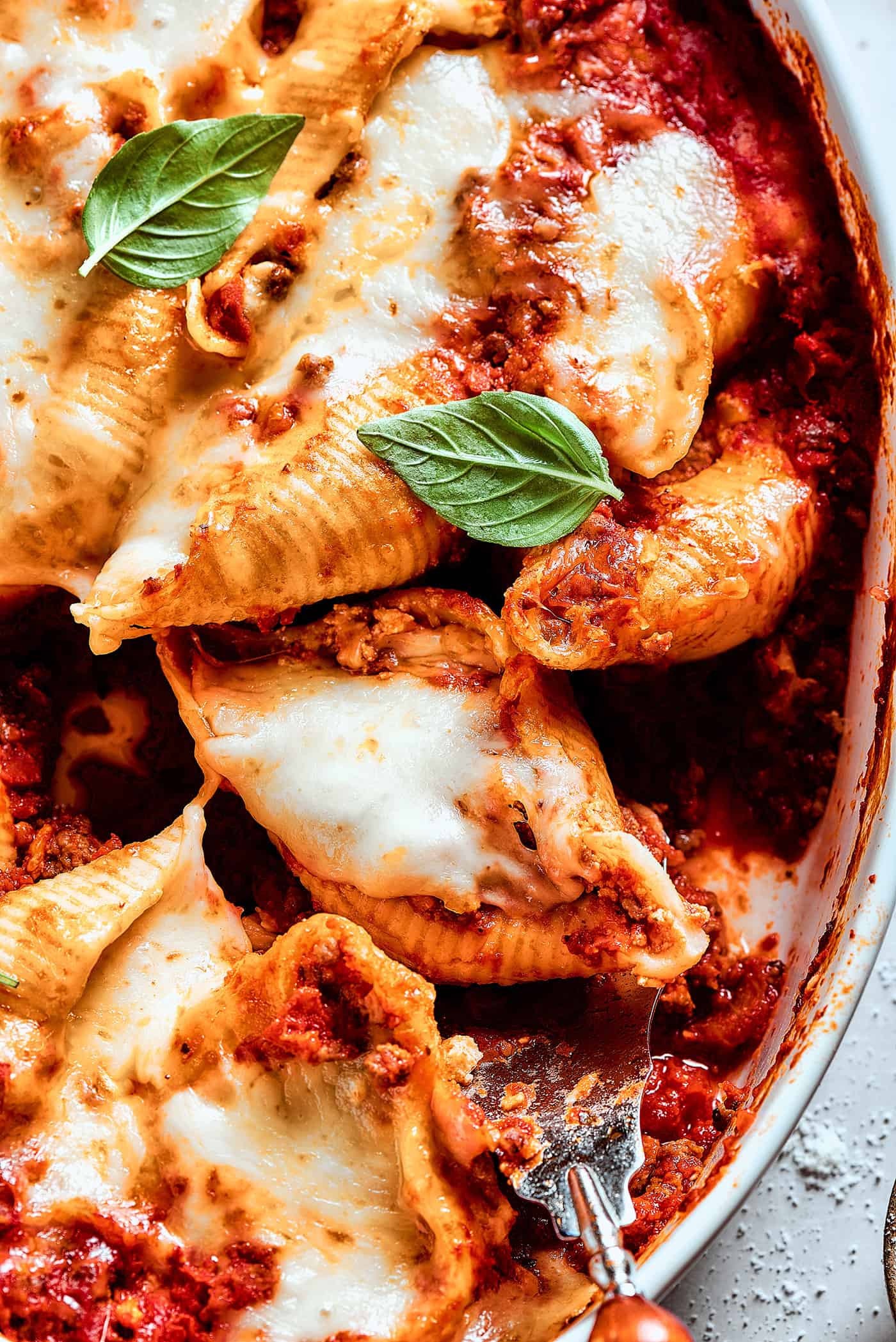 shell pasta stuffed with meat and cheese in a baking dish