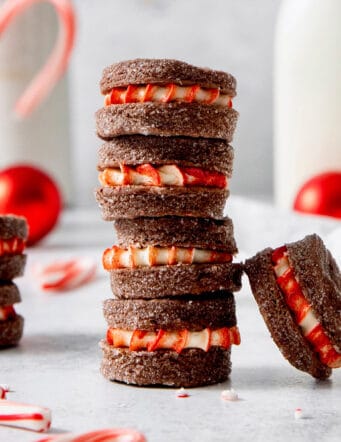 A stack of three chocolate wafer cookies with peppermint filling and more scattered nearby.