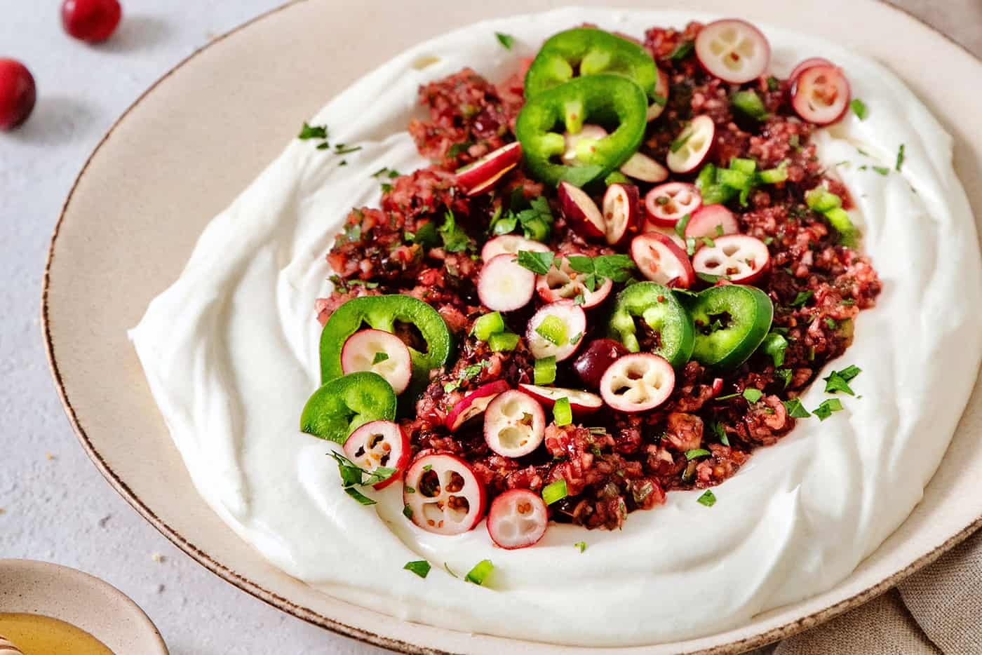 A bowl of cranberry jalapeno dip.