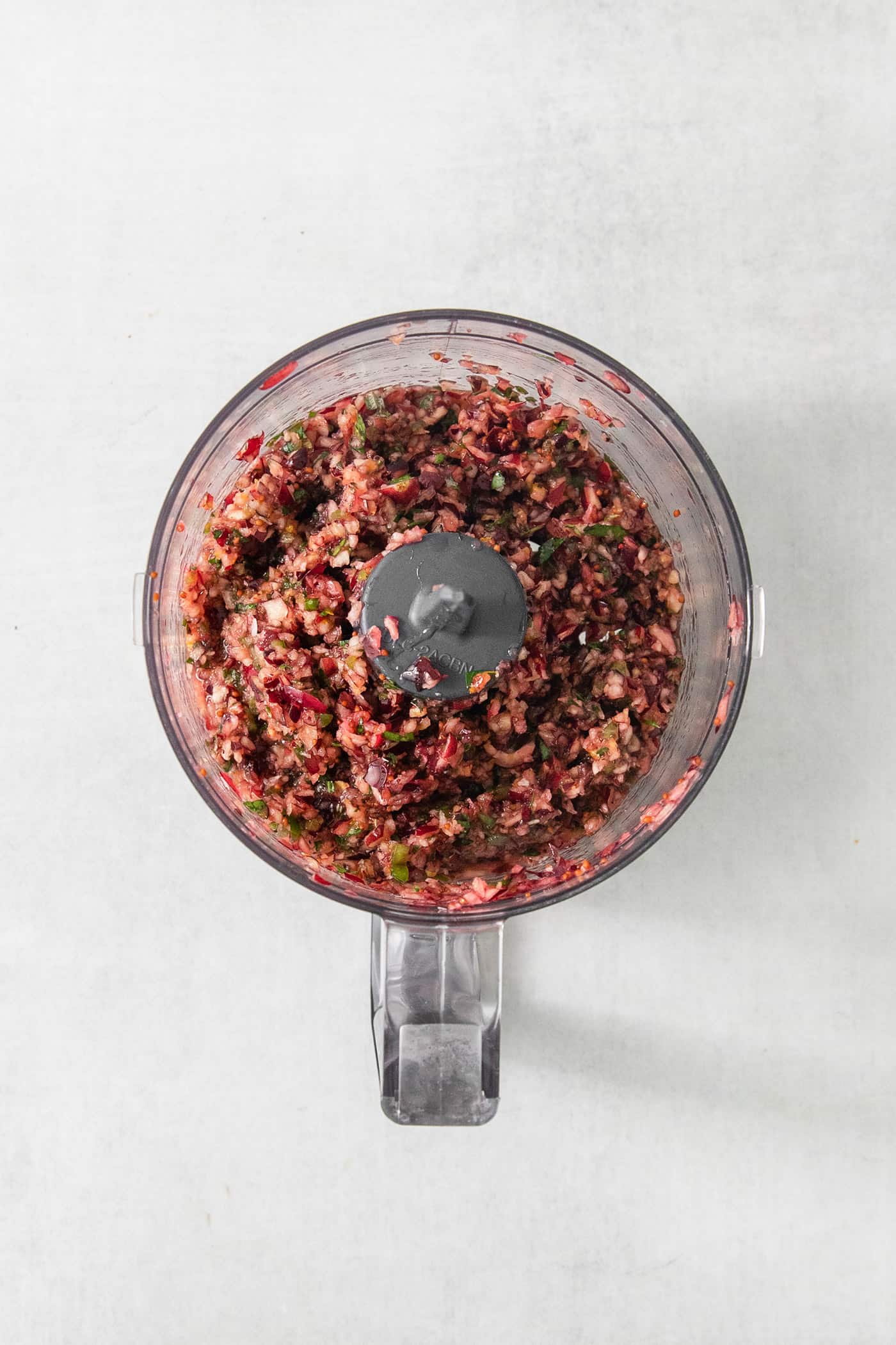 Cranberries are pulsed in a food processor.