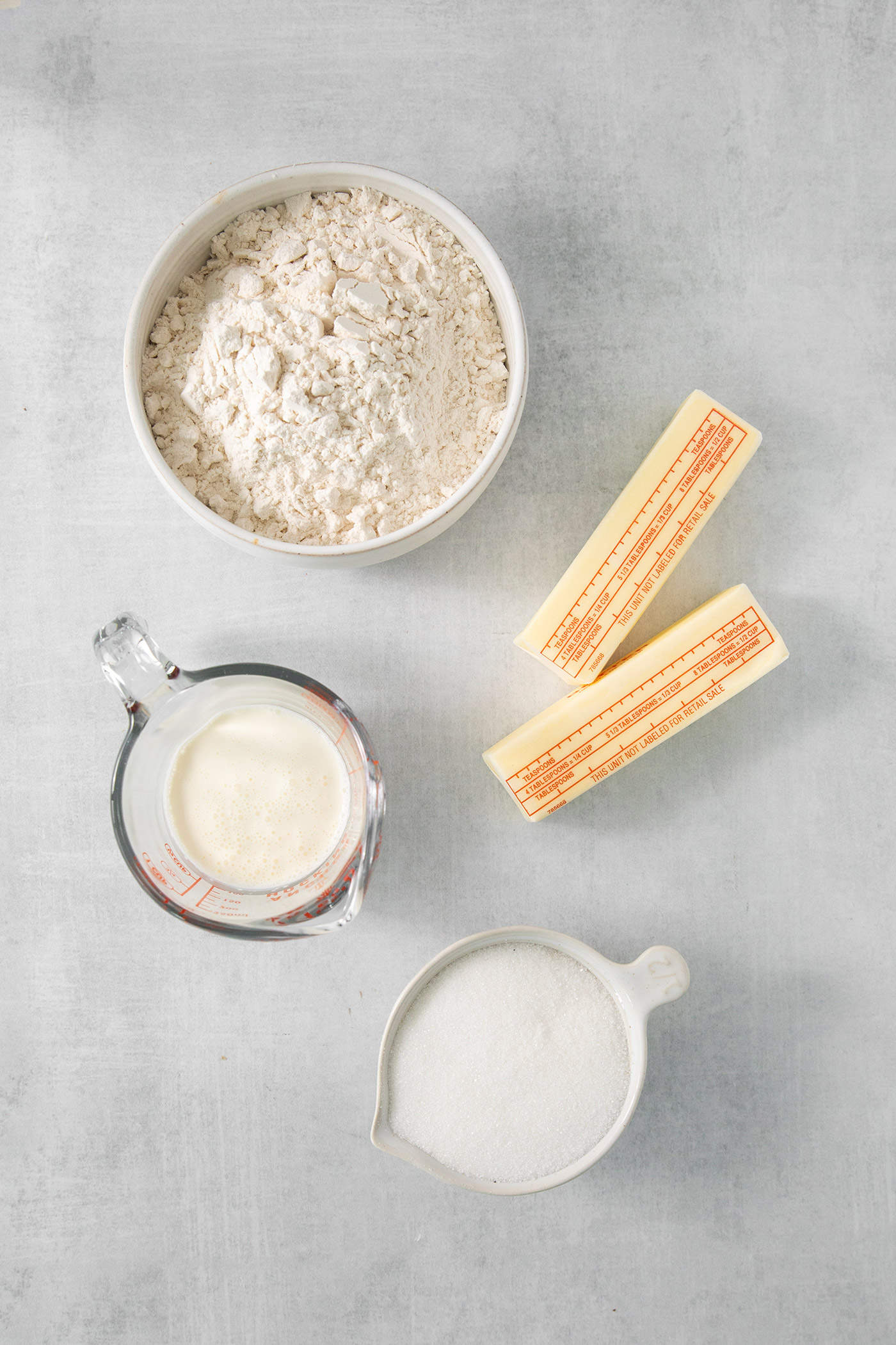 Ingredients for cream wafter cookies are shown on a white background: butter, flour, cream, and milk.