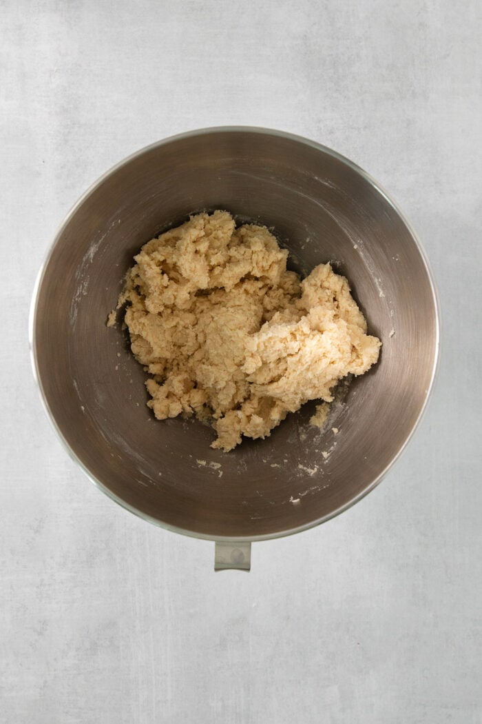 A bowl of cream wafer cookie dough in a metal bowl.