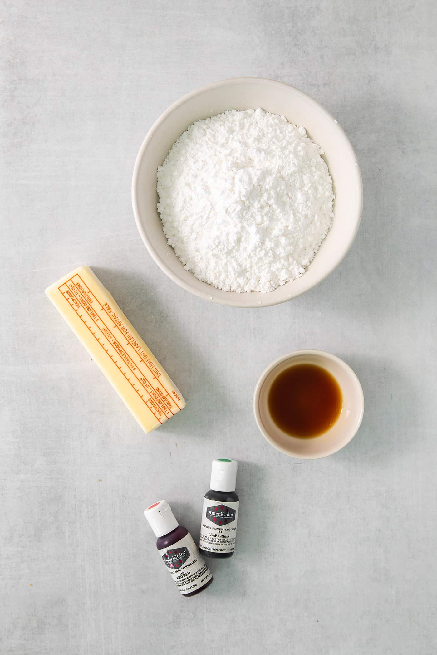 Ingredients for cream wafer cookie filling are shown on a white background: butter, powdered sugar, vanilla, and food coloring.