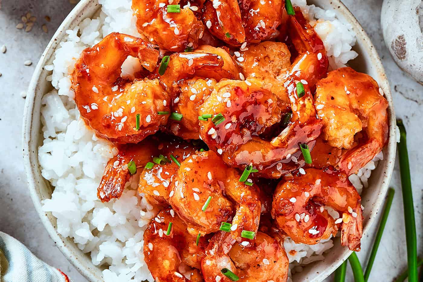 firecracker shrimp over white rice, in a bowl