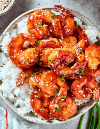 firecracker shrimp over white rice, in a bowl