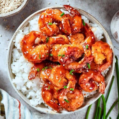 firecracker shrimp over white rice, in a bowl