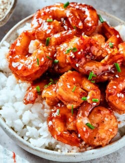 firecracker shrimp over white rice, in a bowl