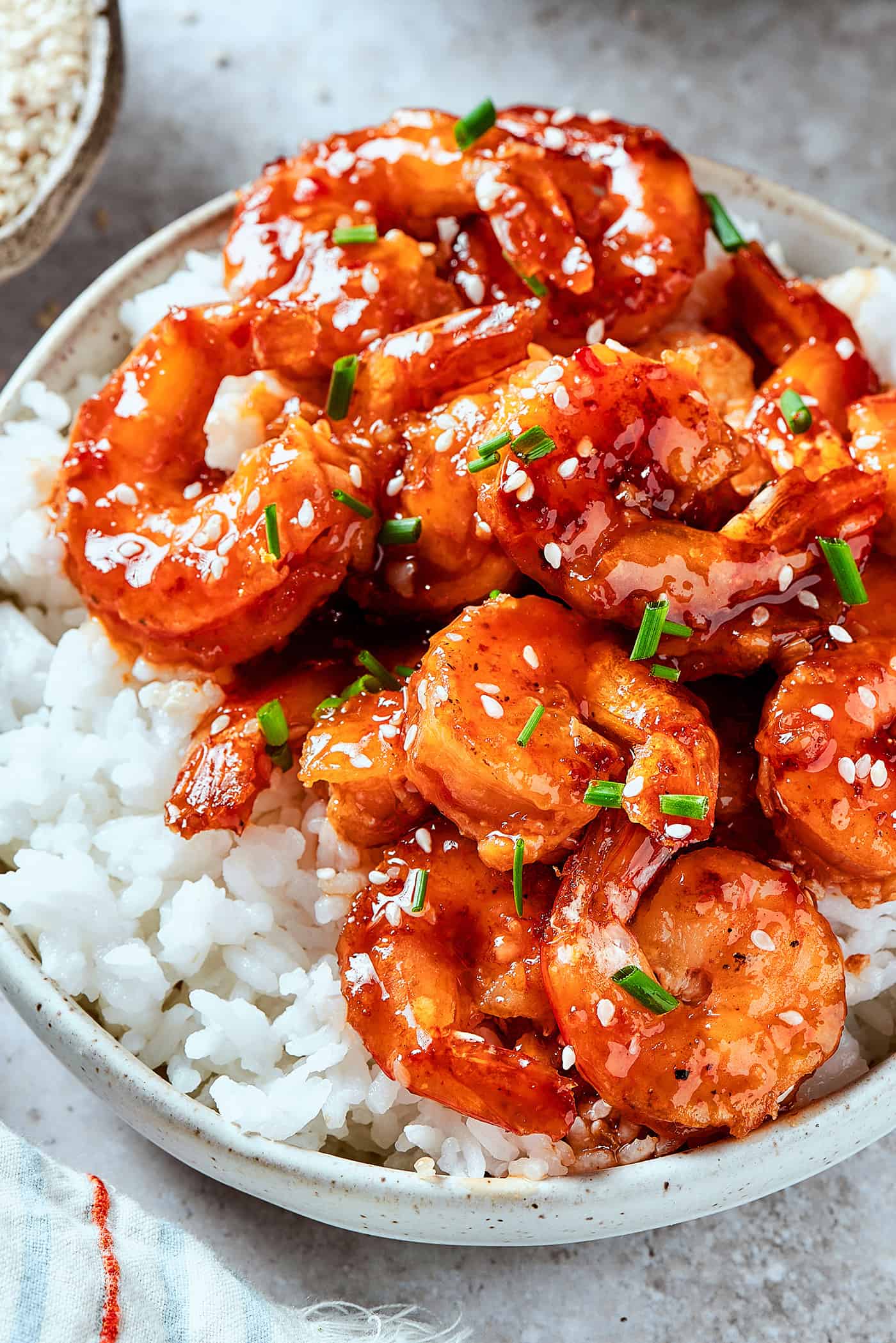 firecracker shrimp over white rice, in a bowl