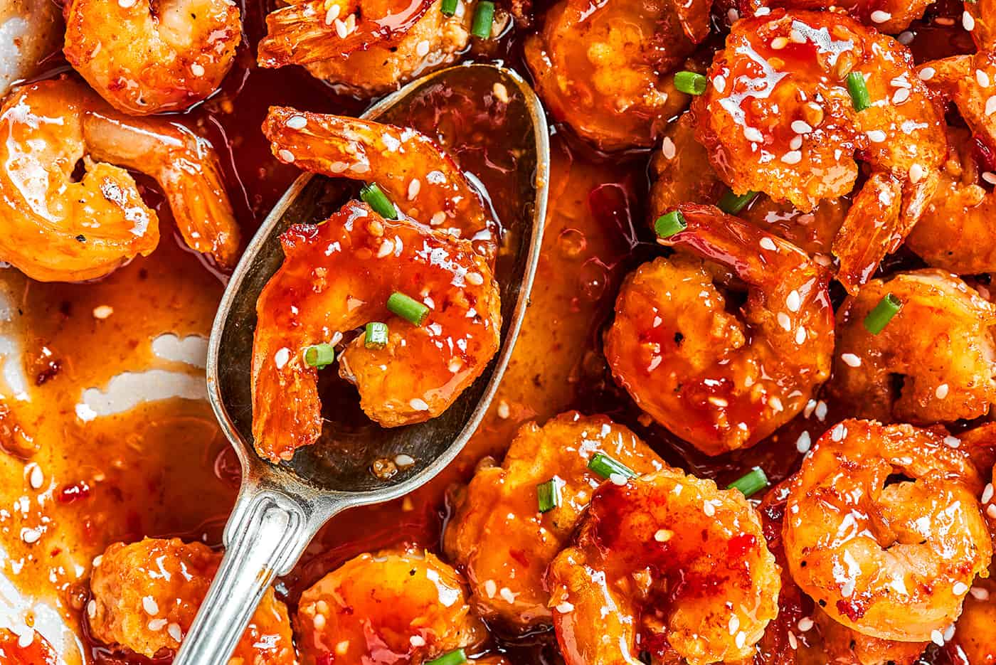 a serving spoon with firecracker shrimp