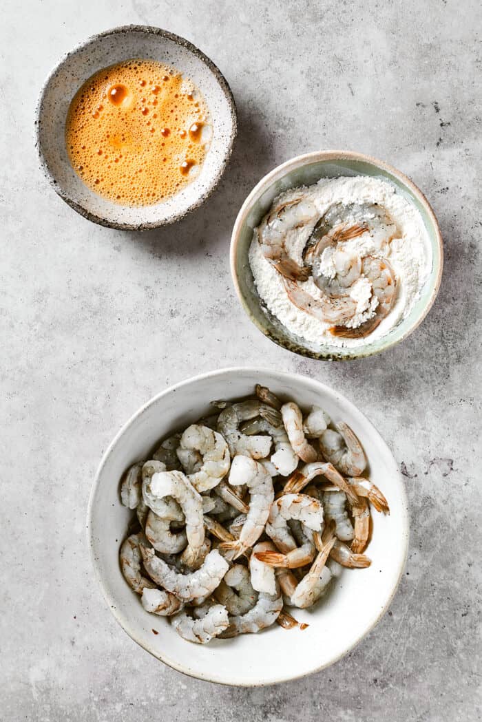 raw shrimp, beaten egg, and flour & cornstarch, all in separate bowls