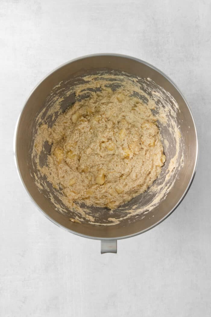 A metal bowl of banana coffee cake batter.
