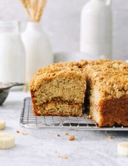A side view of a slice of banana coffee cake shows an interior line of cinnamon.