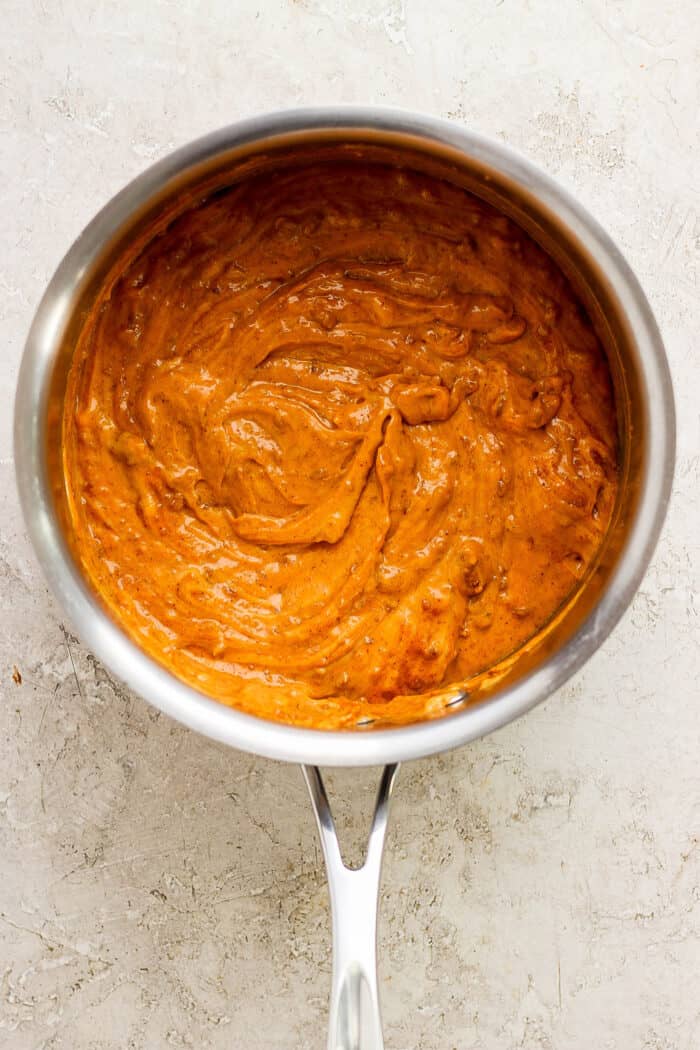 A melted pot of chili cheese dip.